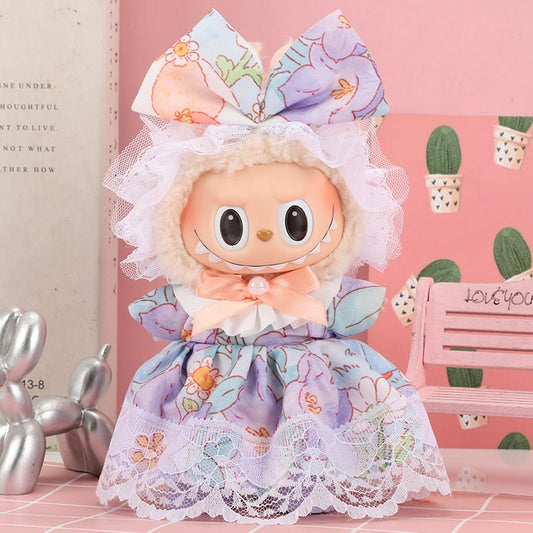 Cute doll with floral dress, lace trim, and large bow.